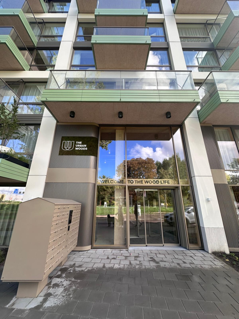 Entrance beneath the balconies – The Urban Woods Delft